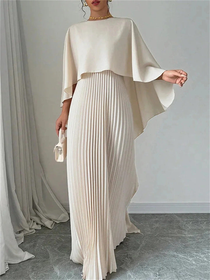 Stylish women's long pleated dress with a graceful cape, a chic choice for formal events.