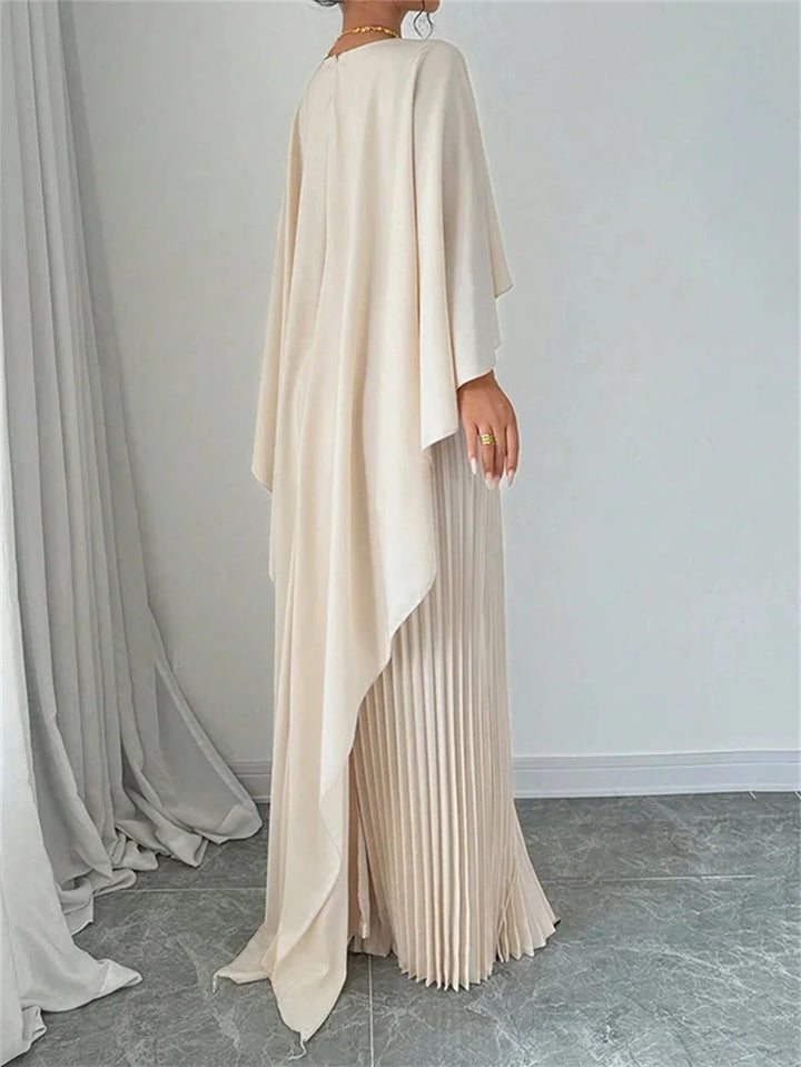 Beautifully pleated bodice & flowing cape on a women's maxi dress, suitable for wedding guests.
