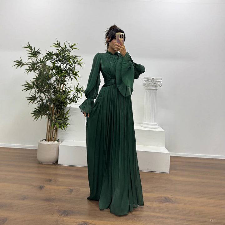 Formal women's pleated maxi dress with elegant long blouson sleeves & wrap waist design.
