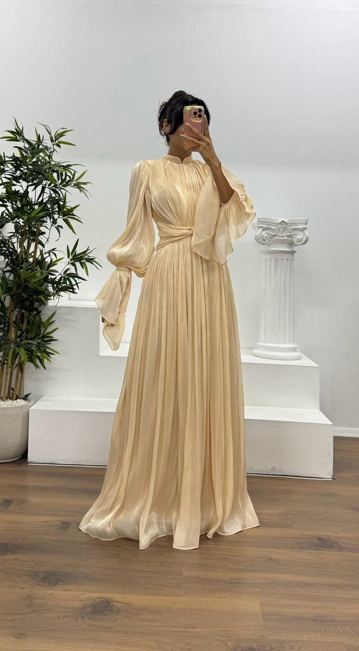 Elegant women's maxi dress, featuring a pleated skirt, long blouson sleeves, and a wrap waist.