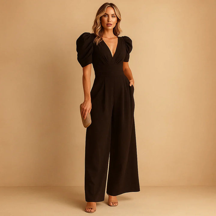 Full shot of a woman wearing a sophisticated puff sleeve jumpsuit, evening wear.