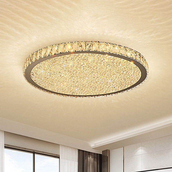 Elegant round crystal LED flush mount light. Modern ceiling fixture provides bright, decorative lighting for home decor.