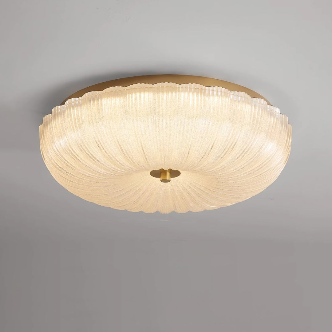Energy-efficient LED round flush mount ceiling light with decorative rippled glass.