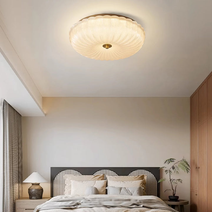 Rippled glass flush mount ceiling light, round design, provides soft LED indoor lighting.