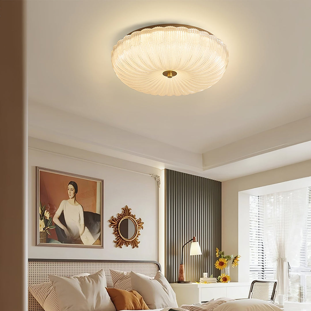 Elegant round flush mount LED ceiling light with a beautiful rippled glass diffuser.