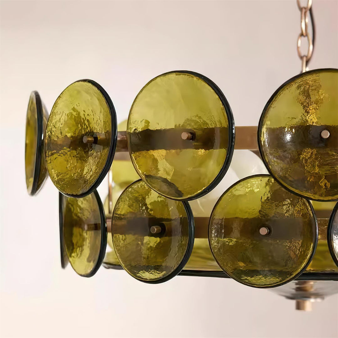 Contemporary round metal & glass chandelier above a stylish dining table.