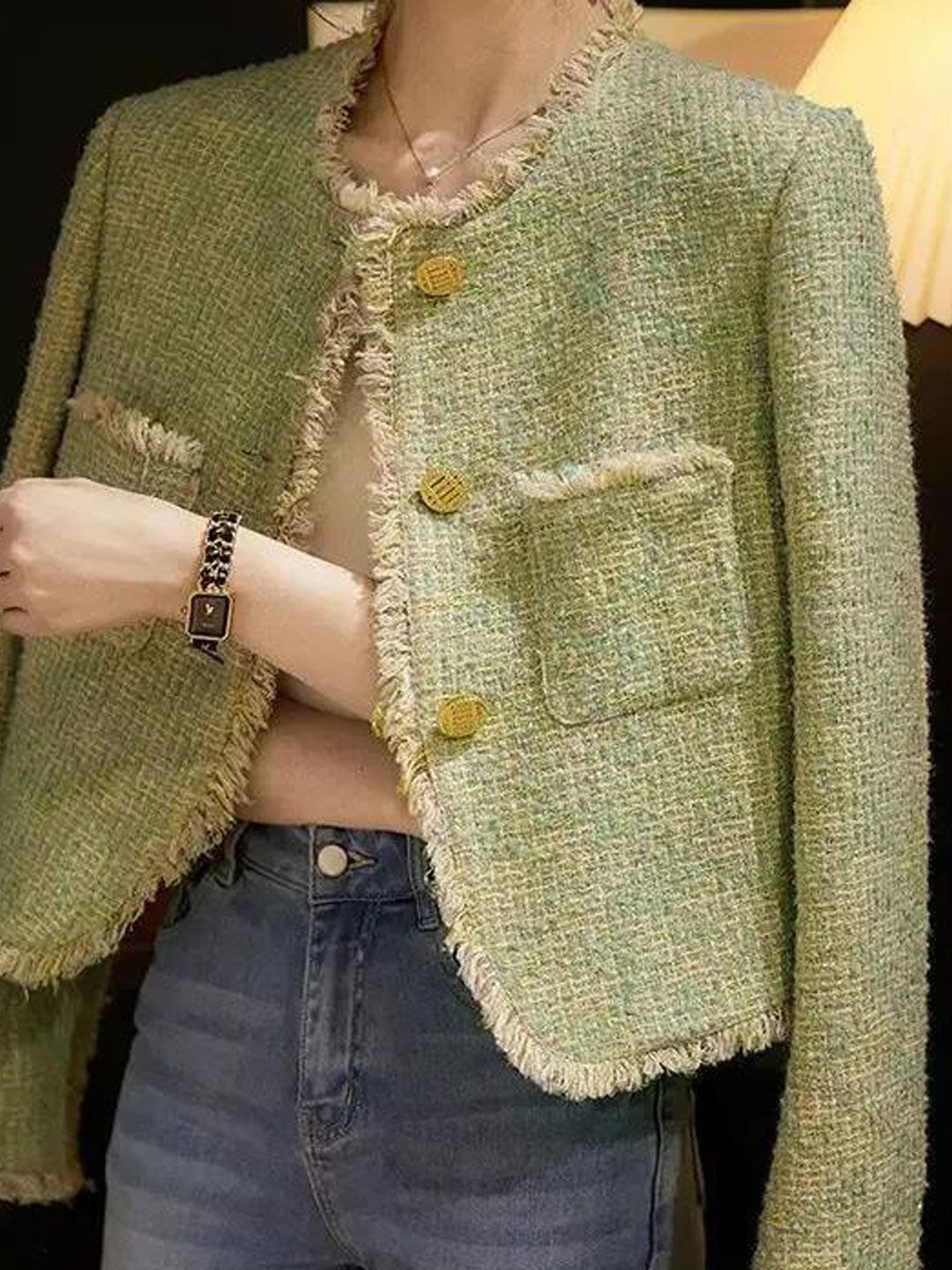 Elegant round neck black tweed jacket for women, chic and sophisticated style.