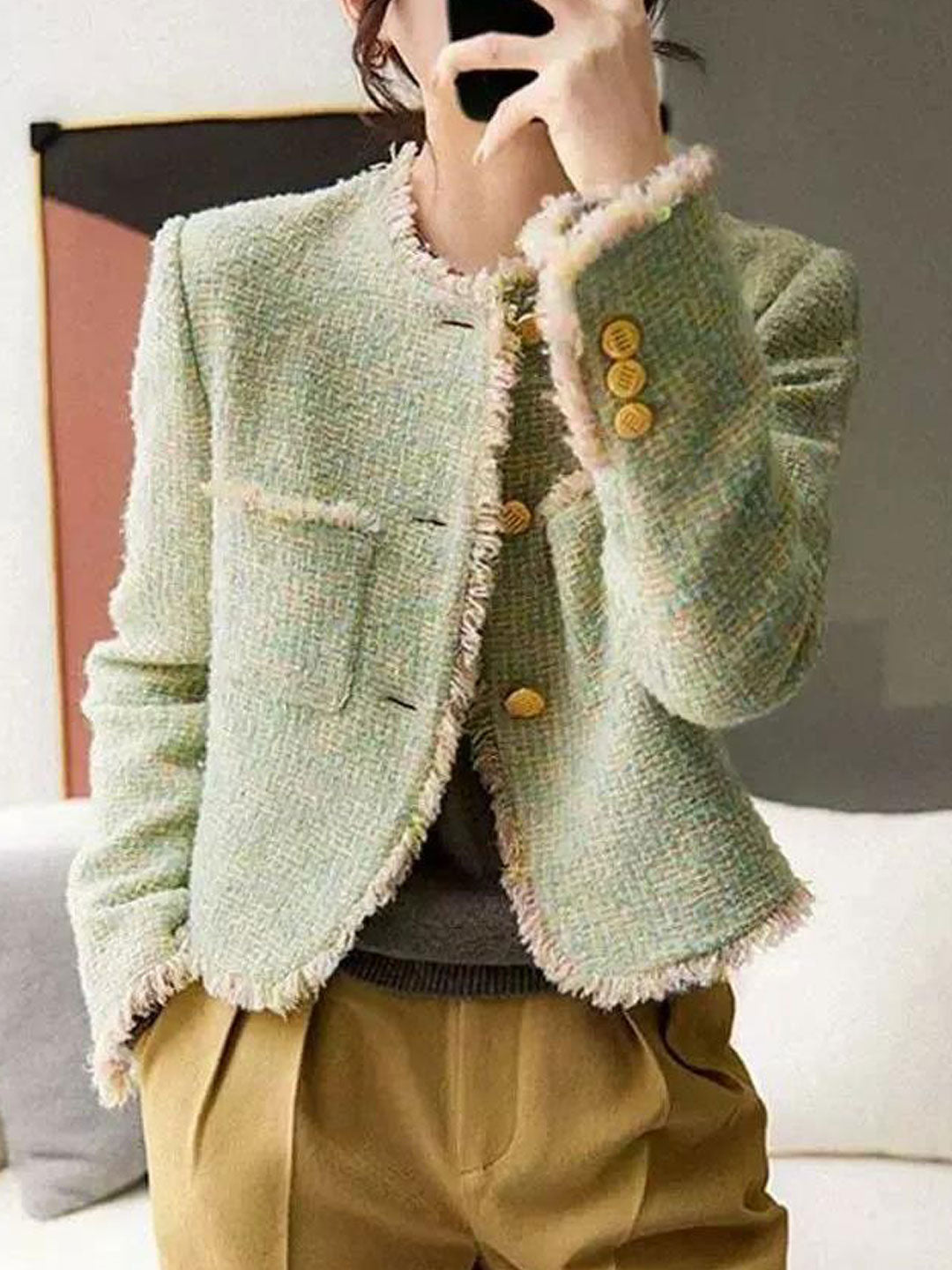 Stylish women's tweed jacket with a timeless round neck design, perfect for elegant outfits.