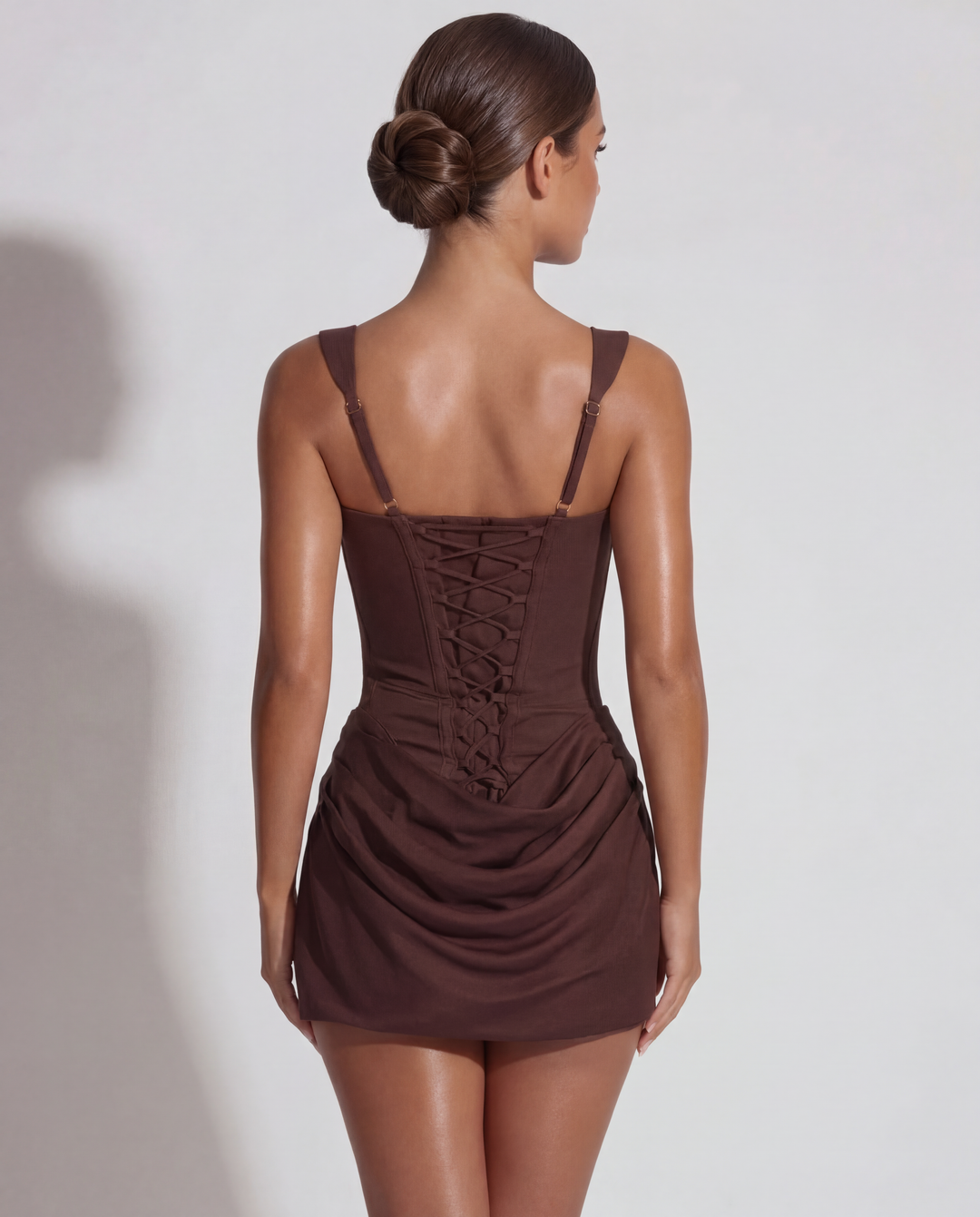 Women's sculpted mini dress with elegant pleated skirt, ideal for evening events & special occasions.