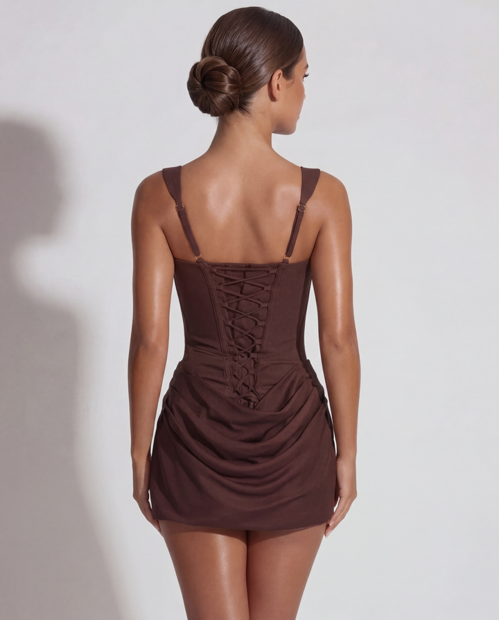 Women's sculpted mini dress with elegant pleated skirt, ideal for evening events & special occasions.