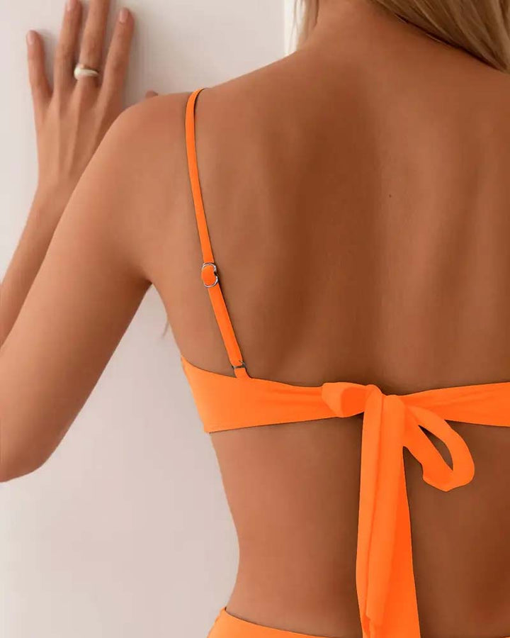 Summer ready: sculpted women's bikini set with chic gold accents and high-waist.