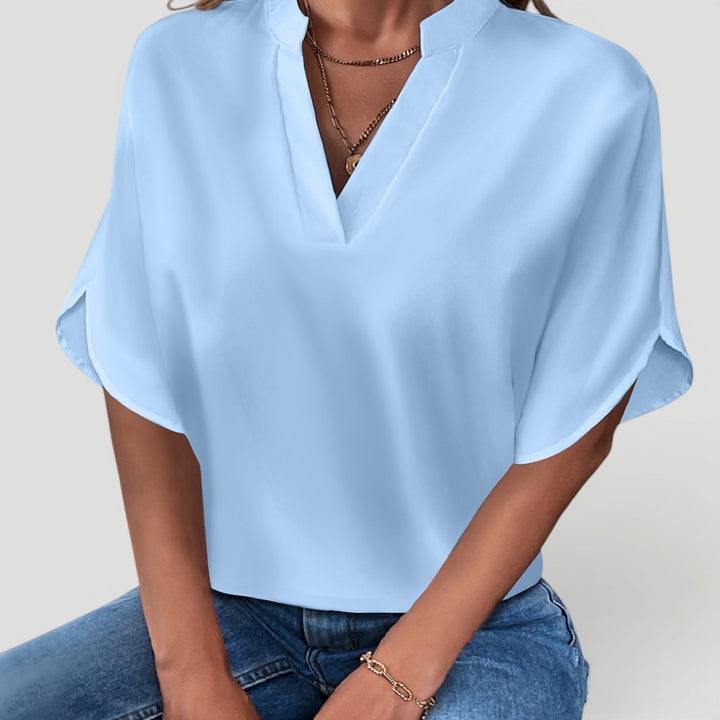 Comfortable short sleeve women's blouse, stylish & versatile for casual chic or office wear.
