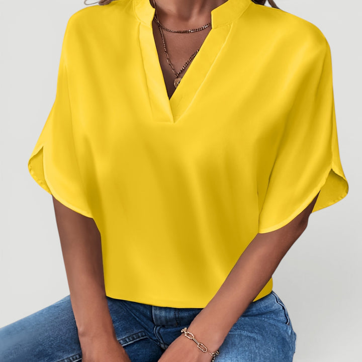 Modern ladies short sleeve blouse, lightweight & versatile for elegant summer or everyday outfits.