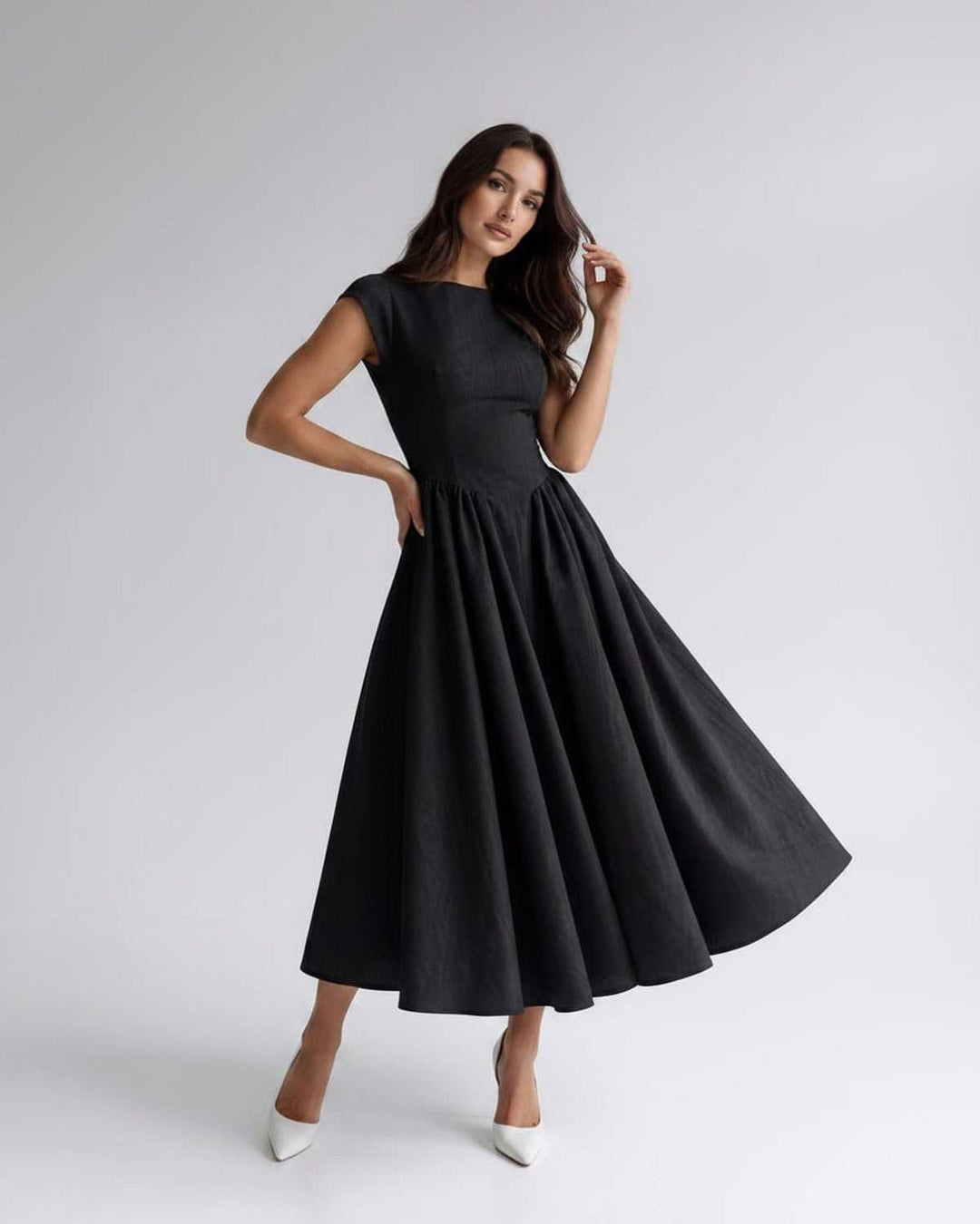 Elegant women's sleeveless A-line midi dress, a timeless formal piece with a graceful gathered waist.