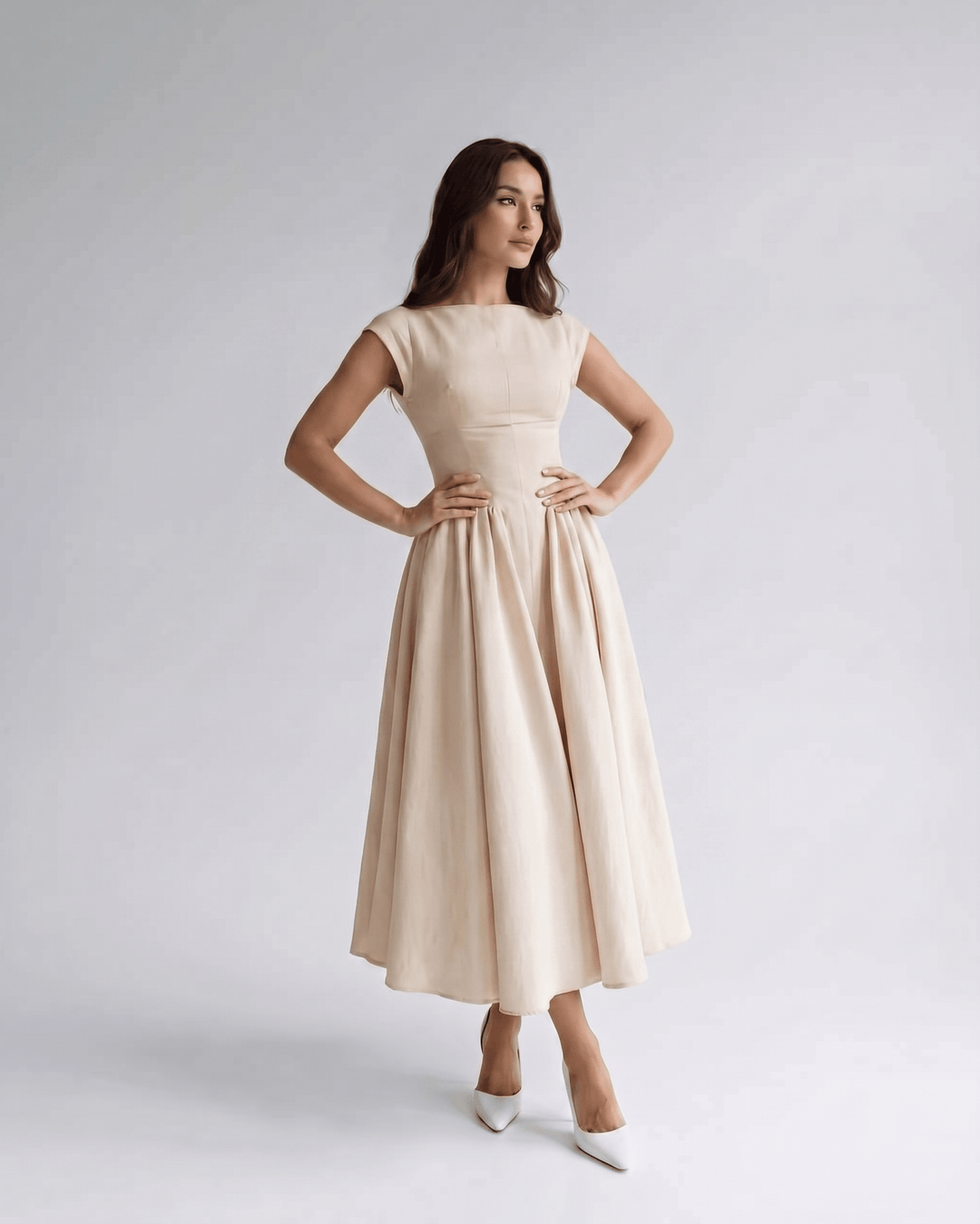 Women's elegant A-line sleeveless midi dress, featuring a gathered waist, perfect for evening events.