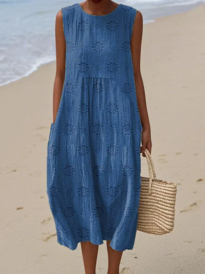 Women's elegant summer midi dress, perfect for vacation. Sleeveless design with convenient pockets.