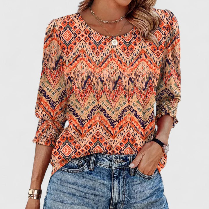 Elegant smocked women's top with long sleeves. Relaxed fit, stylish for casual or dressier occasions.