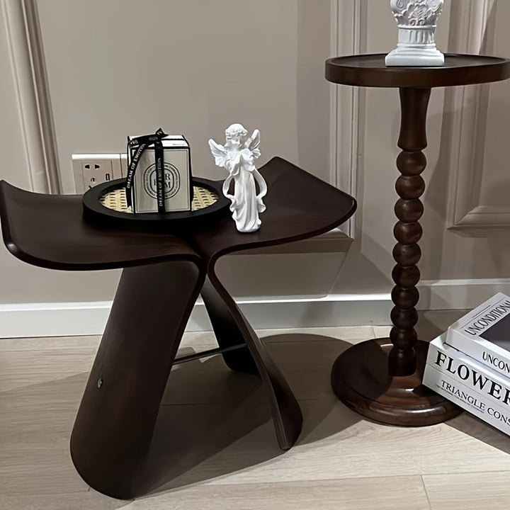 Space-saving solid wood butterfly stool, perfect for small living rooms.
