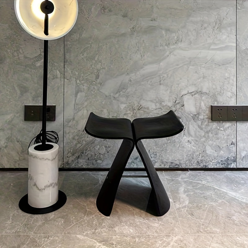Classic butterfly stool design in dark wood, enhancing entryway aesthetics.