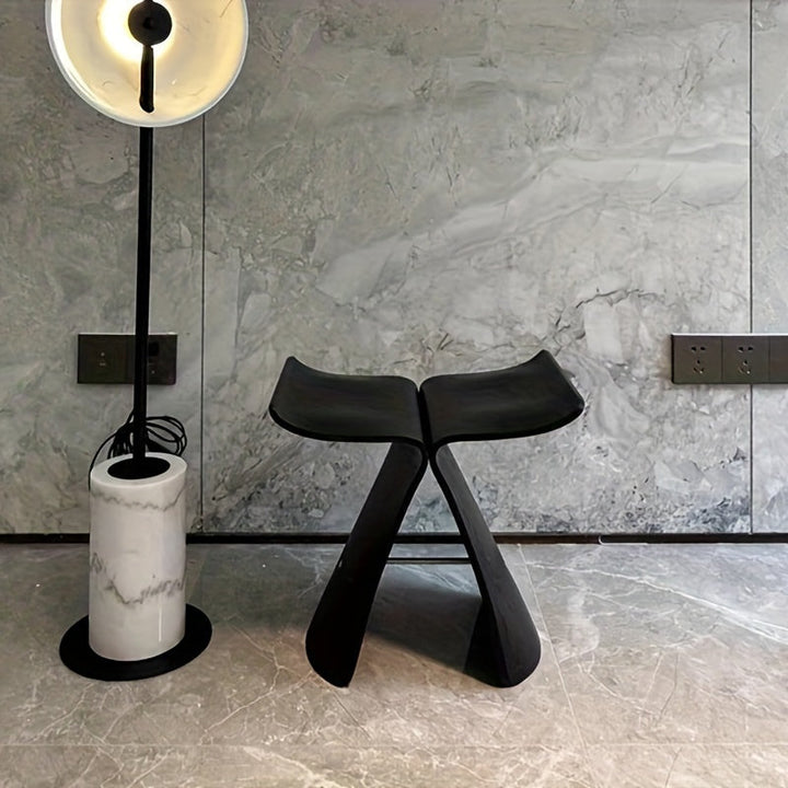 Classic butterfly stool design in dark wood, enhancing entryway aesthetics.