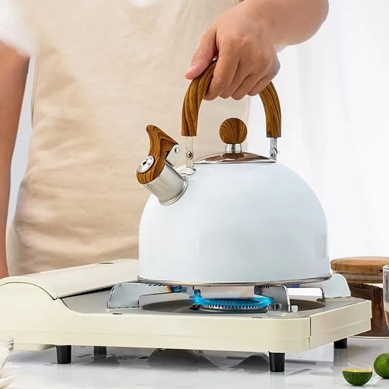 White whistling stovetop kettle with ergonomic insulated handle. Durable stainless steel for hot tea & coffee.
