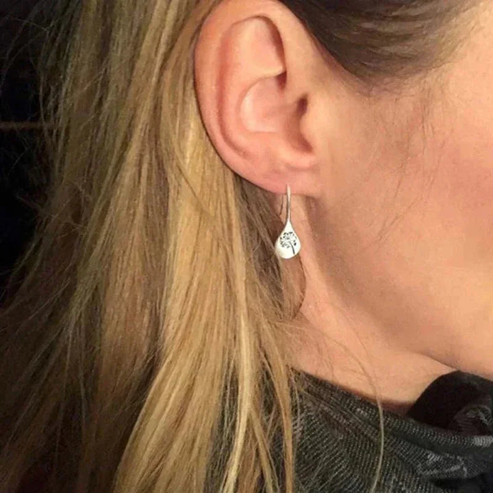 Nature-inspired sterling silver teardrop dangle earrings for women, featuring a beautiful dandelion motif for an elegant look.