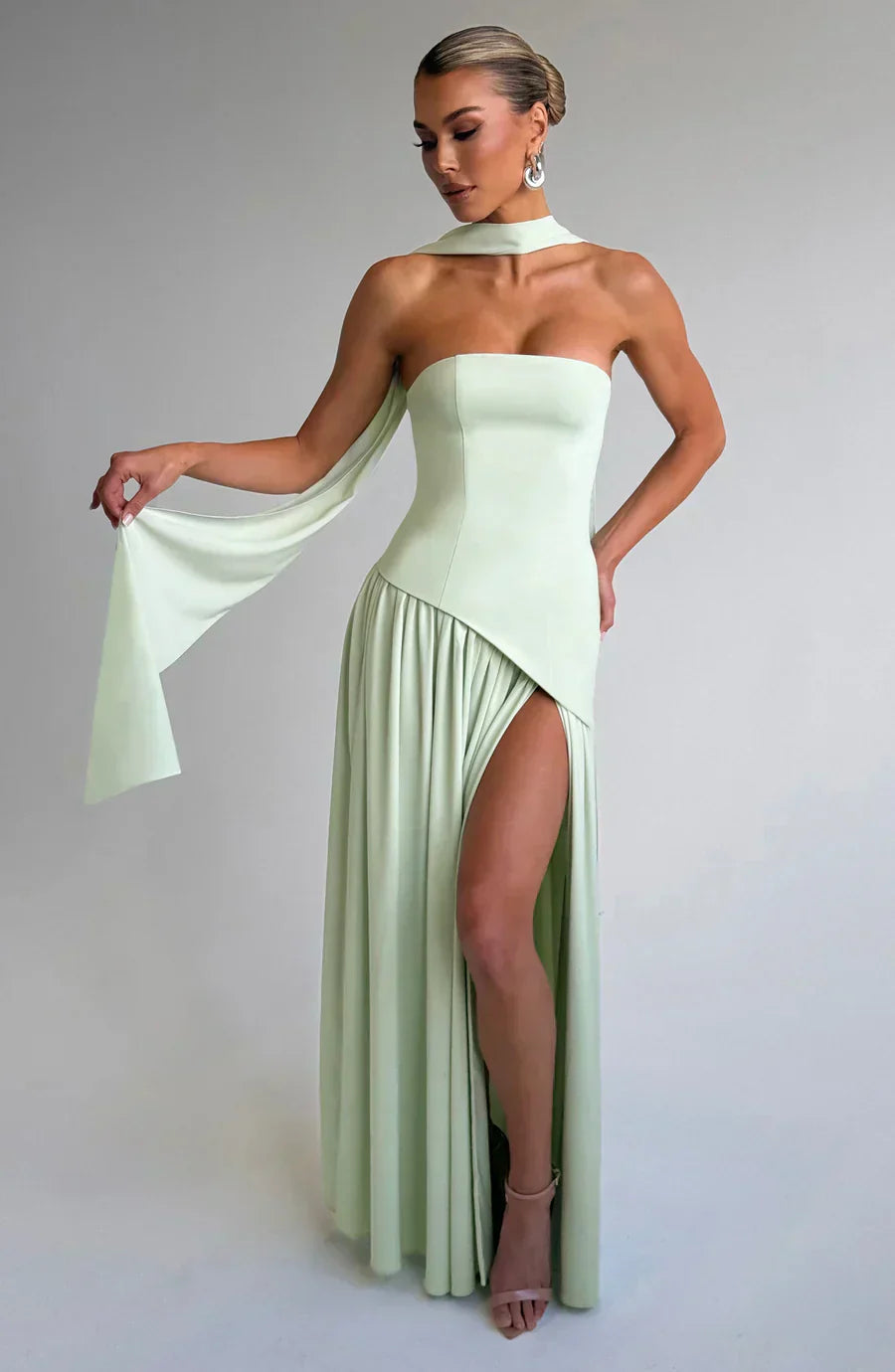 Elegant strapless maxi dress for women, featuring a high slit & asymmetric hem for formal wear.