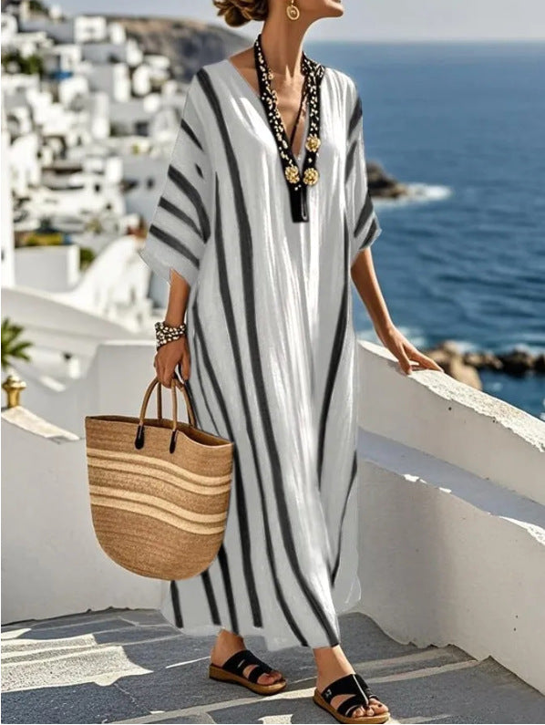 Fashionable striped long kaftan dress for women, offering a relaxed fit and Mediterranean flair.
