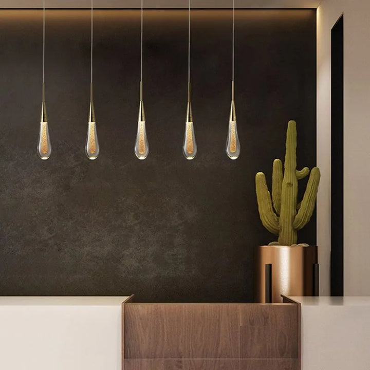 Glamorous teardrop crystal pendant, perfect elegant lighting accent for modern bedroom decor.