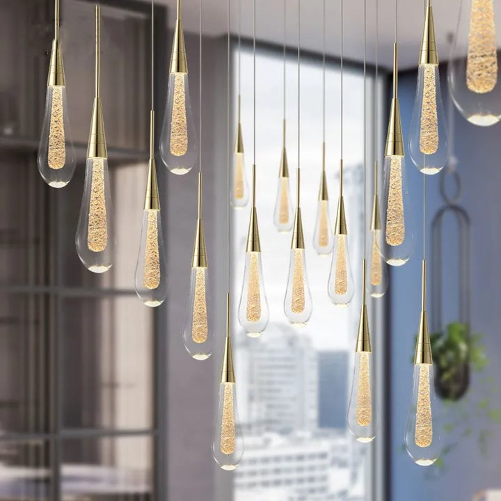 Faceted teardrop crystal pendant light, brilliant modern LED fixture for home interior style.