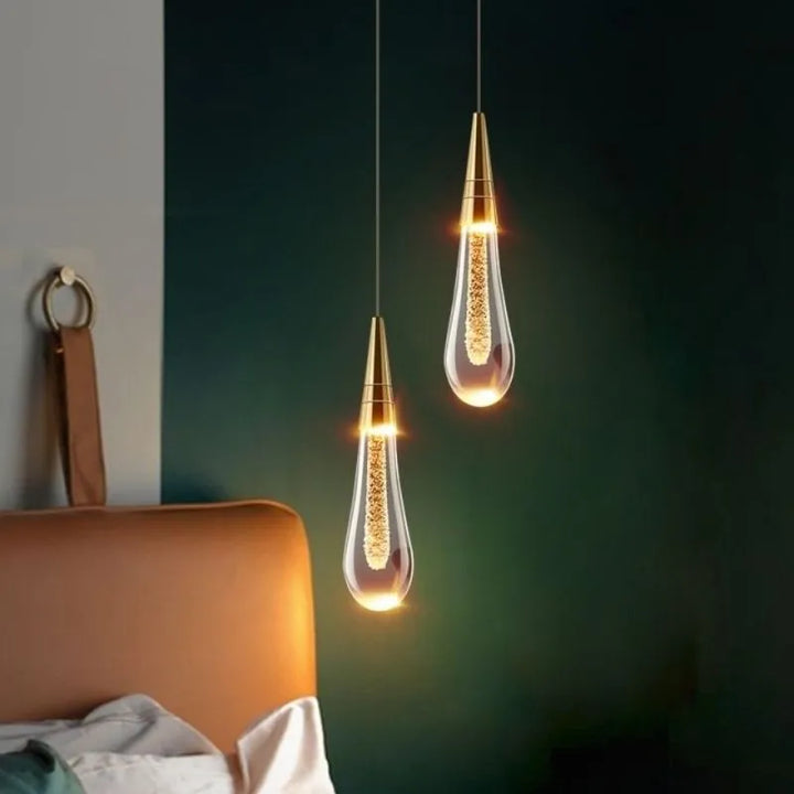 Shimmering teardrop crystal pendant, modern and elegant ceiling light for bedroom or hallway.
