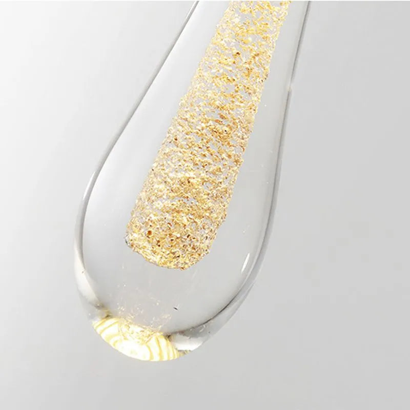 Sleek teardrop crystal LED pendant, adds elegant modern lighting to any home interior.