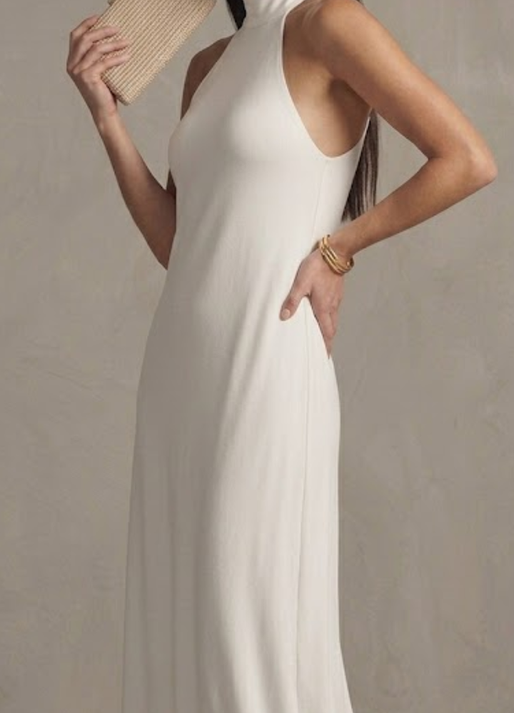 Stylish white halter neck maxi dress for women, perfect elegant occasion wear, a summer dress, or wedding guest outfit.