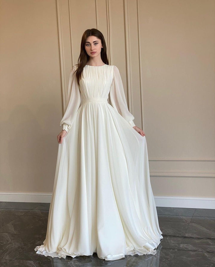 Flowing white long sleeve maxi dress for women. Elegant formal dress with delicate pleats, perfect for special occasions.