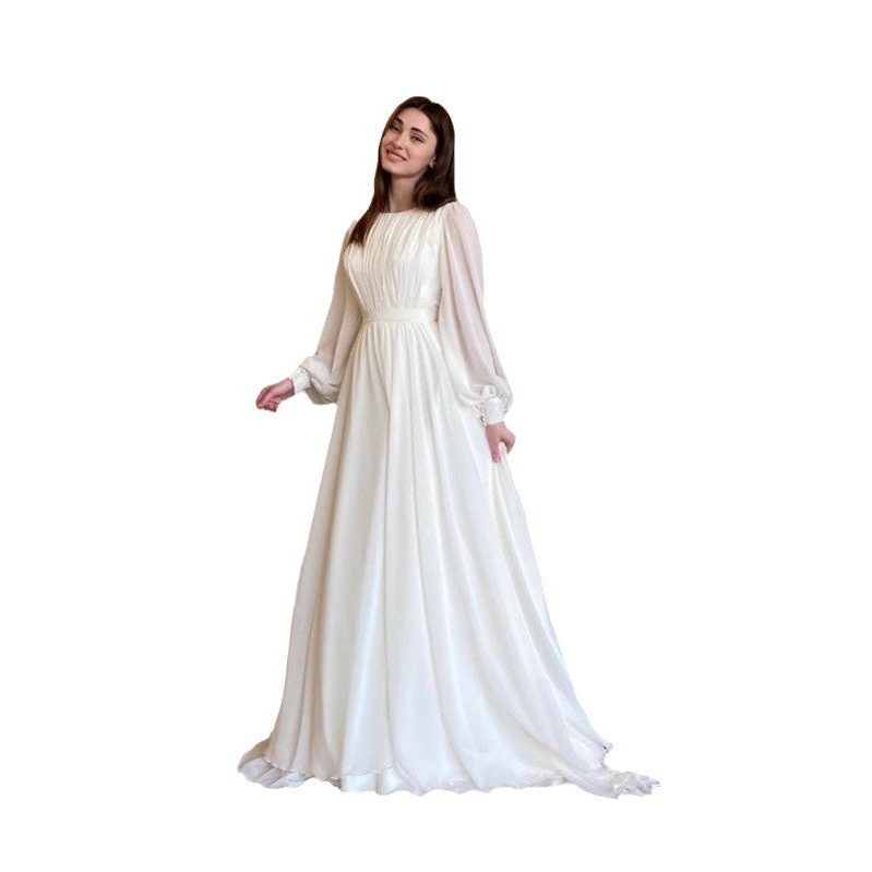 Graceful women's white long sleeve maxi dress, an elegant formal evening gown with flowing fabric for wedding guests.
