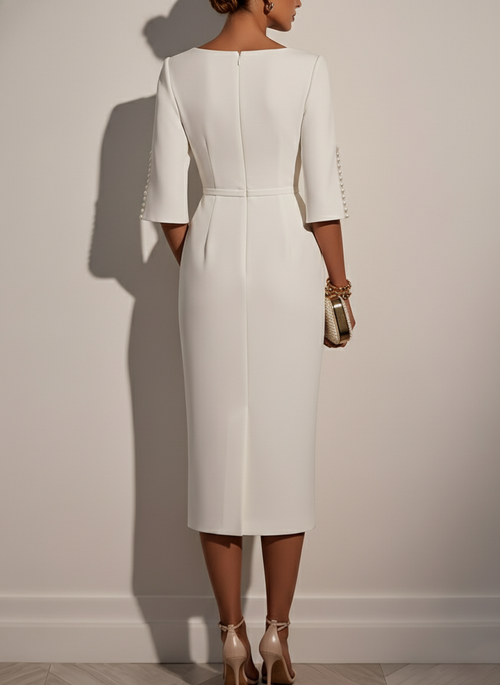 Chic white midi dress with pearl accents, ideal for formal occasions.