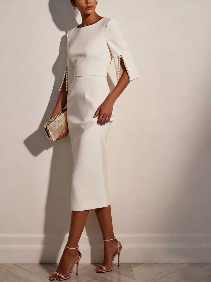 Women's half sleeve sheath dress in classic white, adorned with pearls.