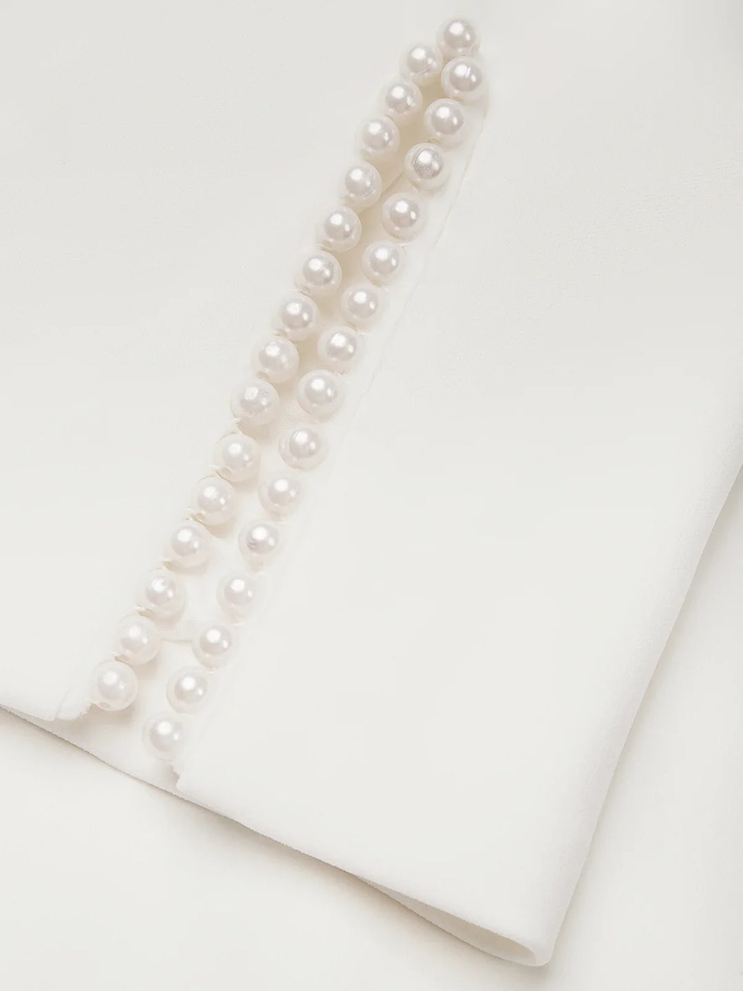 Beautiful white midi dress designed for wedding guests, with pearl trim.