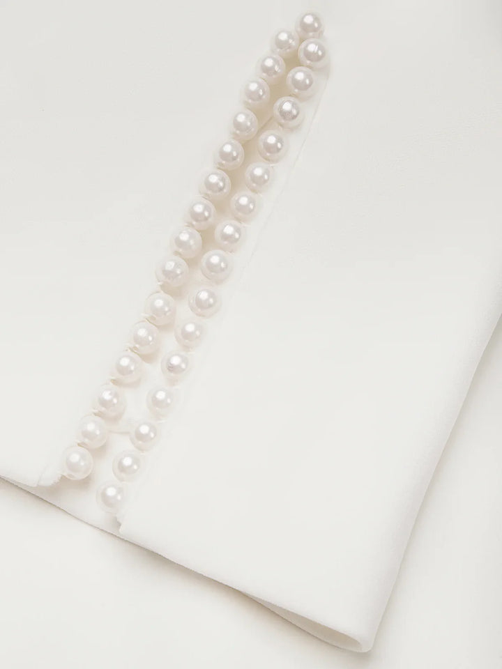Beautiful white midi dress designed for wedding guests, with pearl trim.