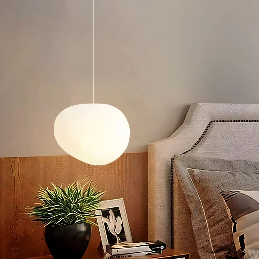Smooth white pebble-shaped pendant light, elegant minimalist ceiling lamp design.