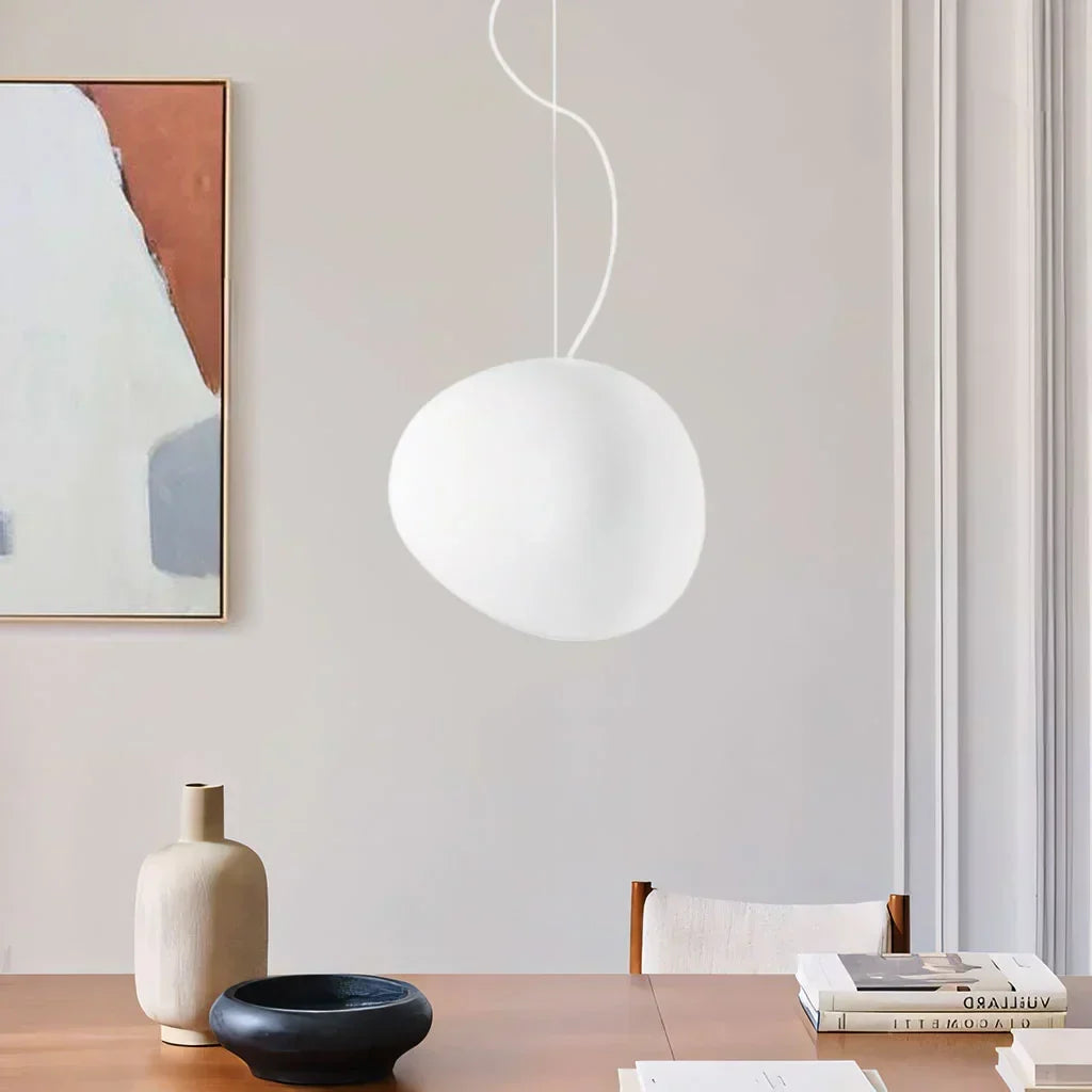 White pebble pendant light, elegant minimalist ceiling fixture. Modern indoor decor lighting.