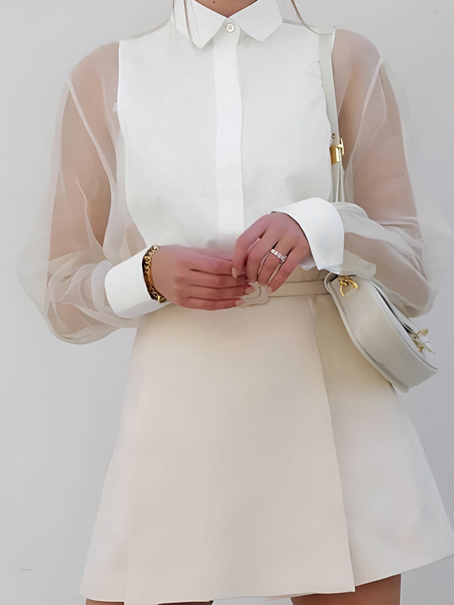 Elegant white sheer sleeve shirt & structured mini skirt set for women. Chic, versatile office or evening wear.