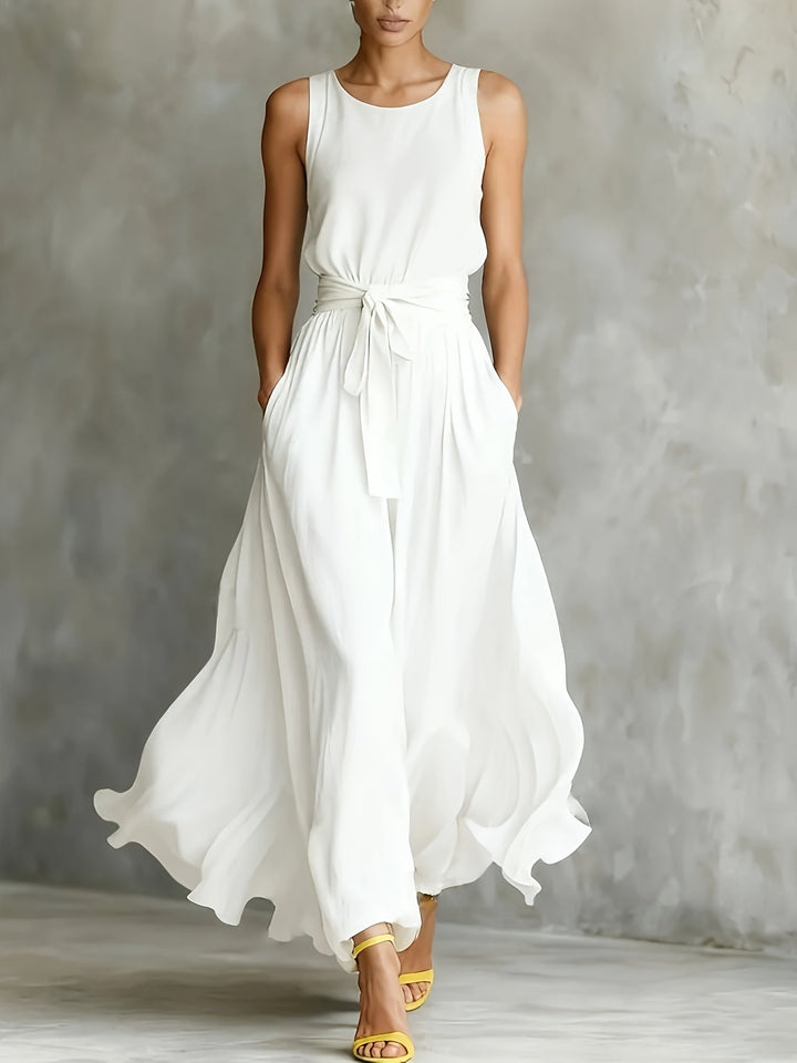 Chic women's white maxi dress, A-line cut with a belt. Sleeveless design, ideal for versatile elegant summer wear.