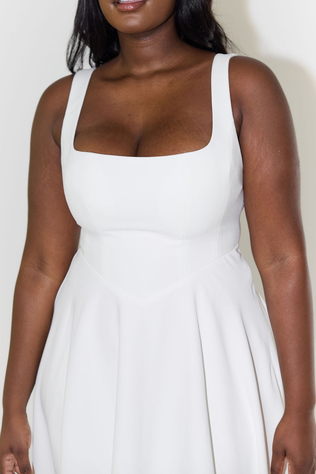 Model wearing a chic black square neck midi dress, perfect women's formal wear or elegant summer style.