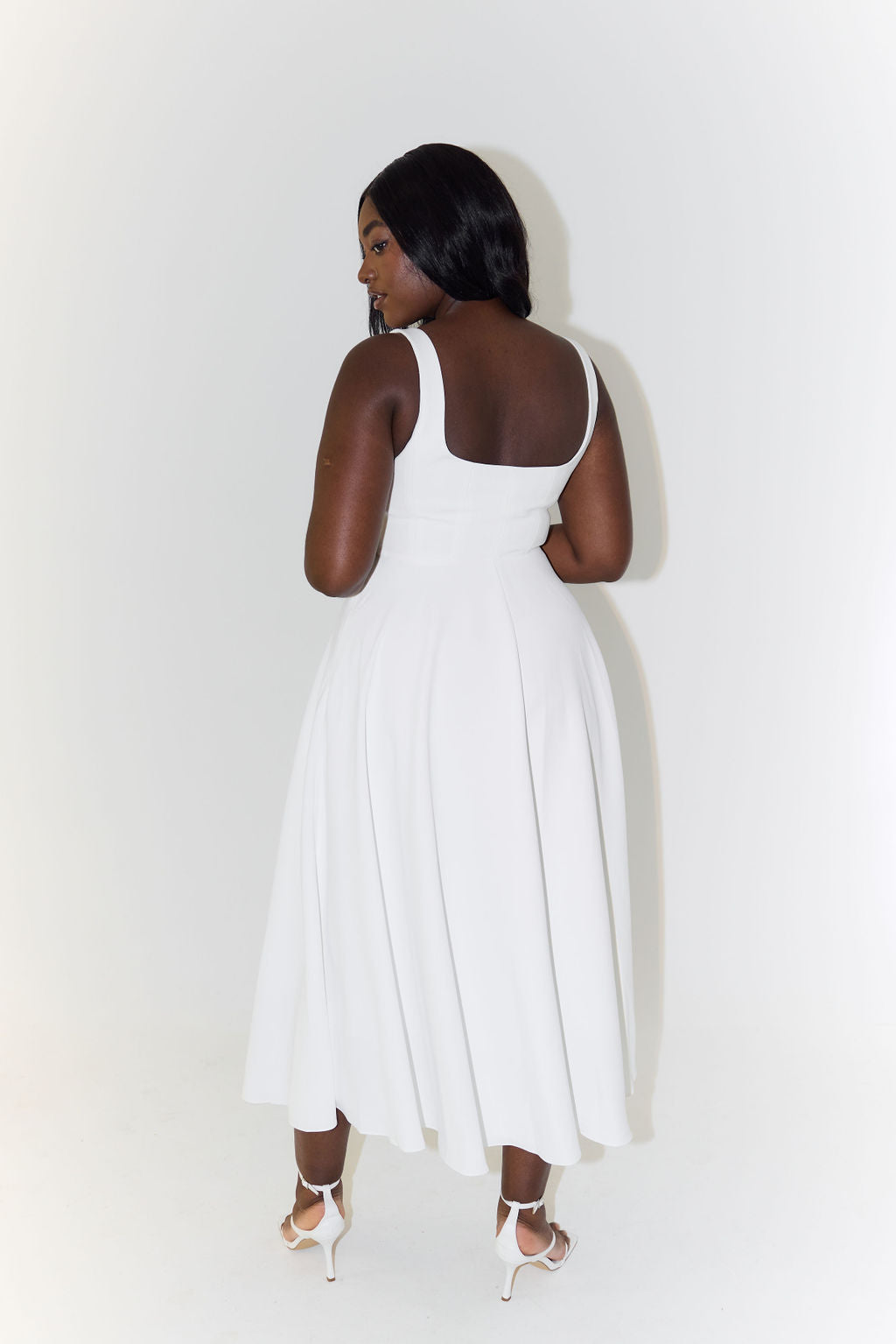Model in a vibrant green elegant square neck A-line midi dress, ideal for spring/summer fashion & occasions.