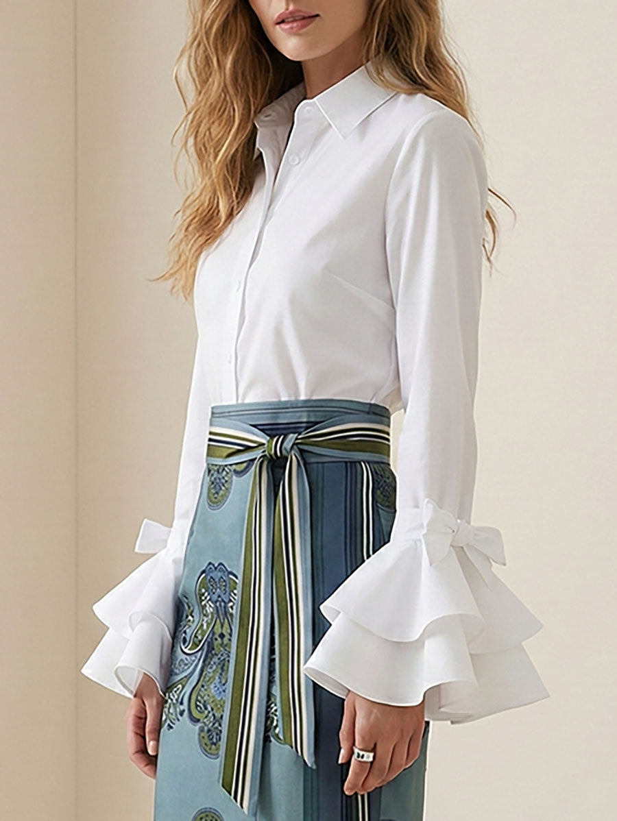 Chic women's button up blouse with tiered ruffles and elegant flare cuffs. Ideal for a refined look.