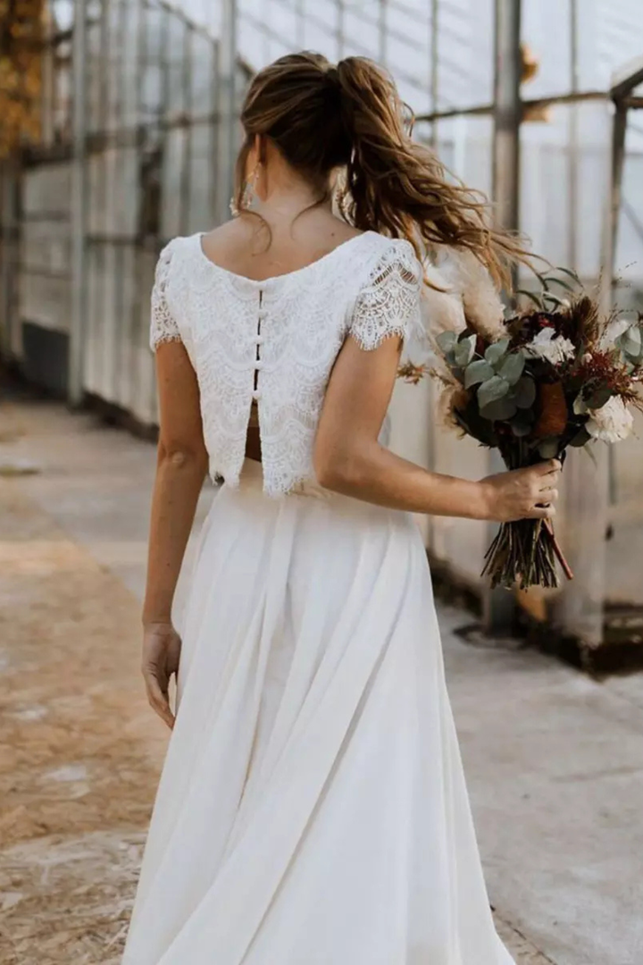 Women's formal white two-piece maxi skirt and top set, an elegant occasion dress for wedding guests.