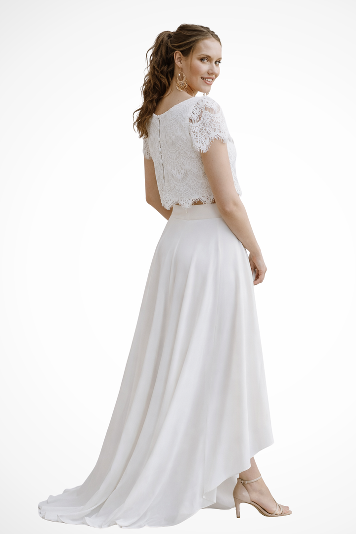Women's white elegant two-piece top & maxi skirt set, perfect for special occasions & evening wear.