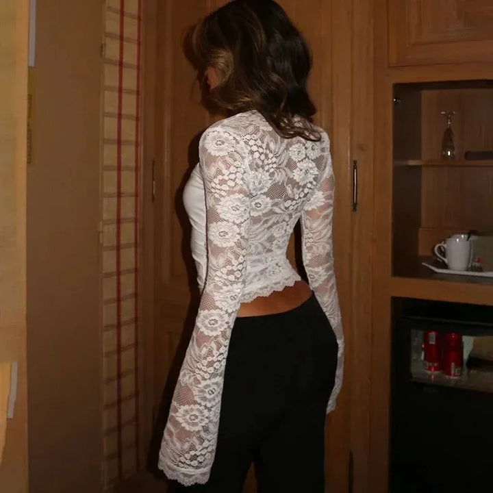 Chic black semi-sheer women's long sleeve top with modern flared sleeves, versatile for elegant fashion.