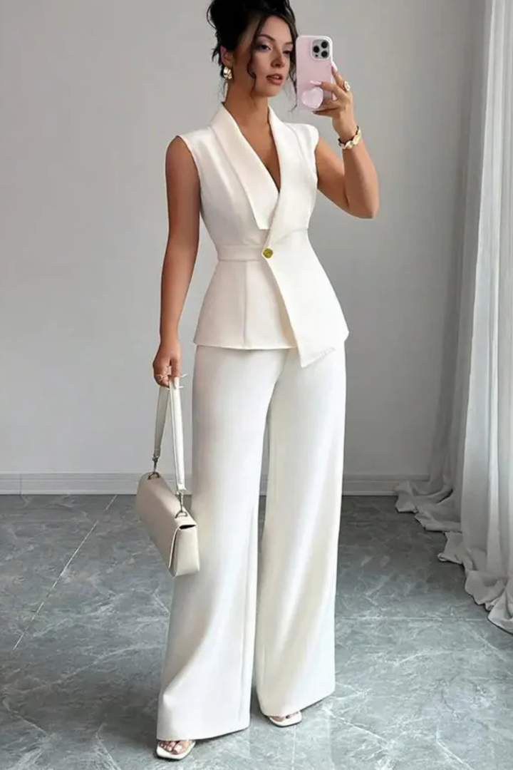 Women's white V-neck sleeveless blazer and wide-leg trouser suit. Versatile for office or elegant evening wear.